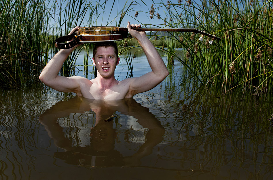 Hamish Davidons holds his banjo above water